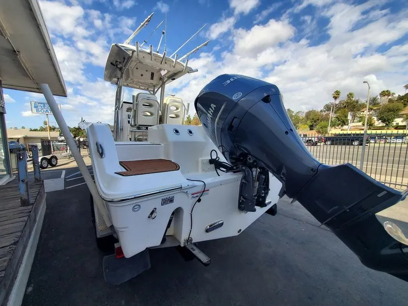 Slide: The Image of 2018 Sea Fox 266 Commander boat with Yamaha outboard motor, parked outdoors. - 3