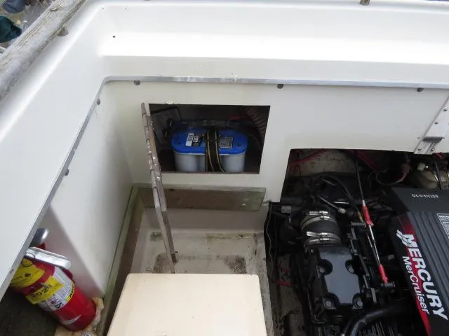 Slide: The Image of 1973 Slickcraft SS235 boat engine compartment with Mercury motor and battery. - 13
