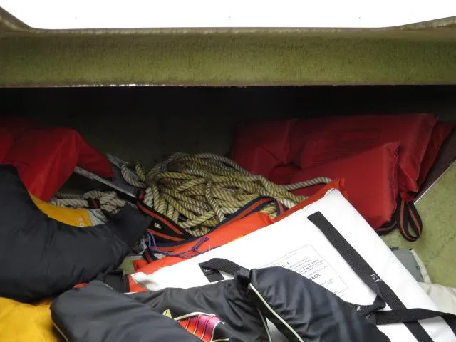Slide: The Image of Storage compartment in a 1973 Slickcraft SS235 boat with ropes and life jackets. - 17
