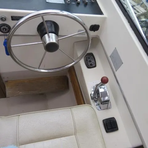 Slide: The Image of 1973 Slickcraft SS235 boat helm with steering wheel and throttle controls. - 18