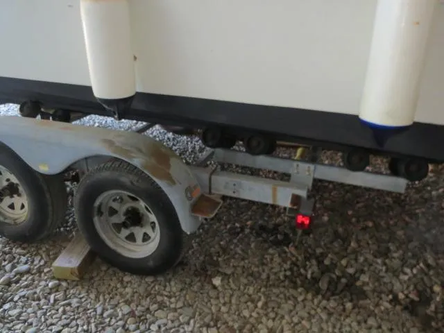 Slide: The Image of Trailer supporting a 1973 Slickcraft SS235 boat on gravel surface. - 25