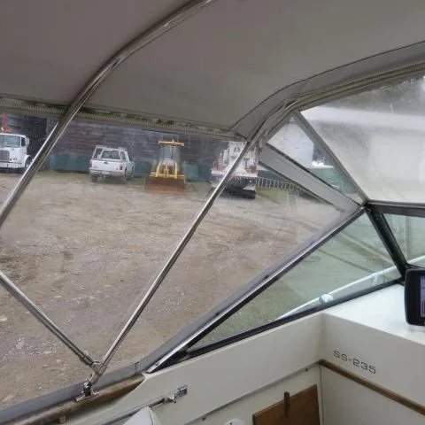 Slide: The Image of 1973 Slickcraft SS235 boat interior with view of parked vehicles outside. - 5