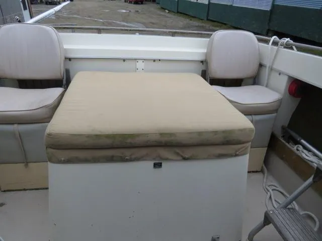 Slide: The Image of 1973 Slickcraft SS235 boat interior with cushioned seating and storage area. - 7