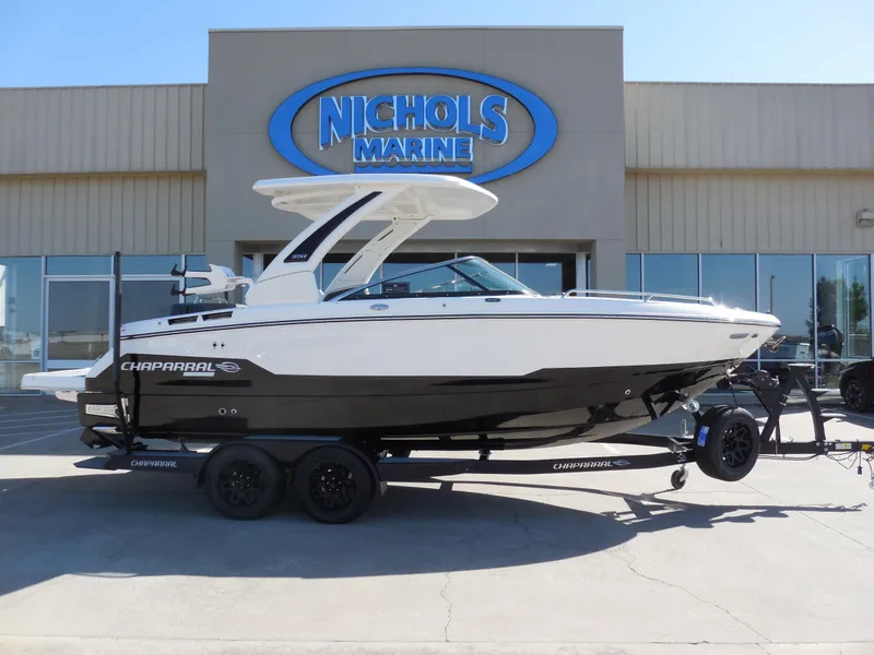 Slide: The Image of 2025 Chaparral 26 Surf boat on trailer at Nichols Marine dealership. - 1