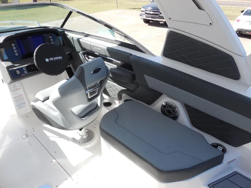Slide: The Image of 2025 Chaparral 26 Surf boat interior with modern dashboard and seating. - 10