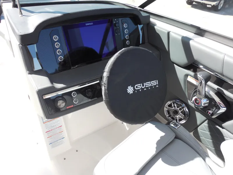 Slide: The Image of 2025 Chaparral 26 Surf boat dashboard with Gussi Italia steering wheel and modern controls. - 11