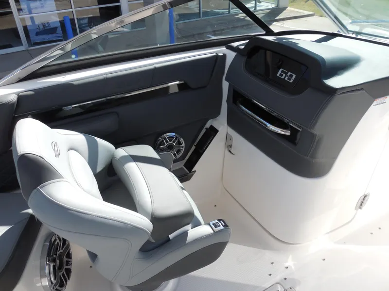 Slide: The Image of 2025 Chaparral 26 Surf boat interior with modern dashboard and comfortable seating. - 12