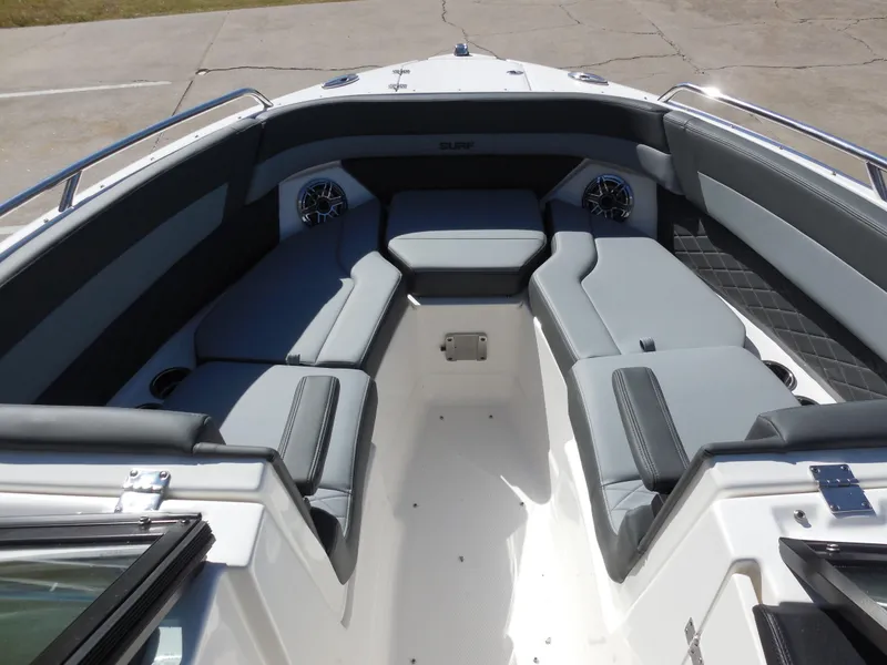 Slide: The Image of 2025 Chaparral 26 Surf boat interior with gray seating and speakers. - 13