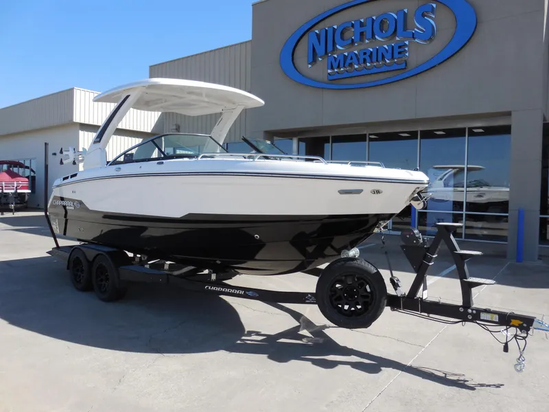 Slide: The Image of 2025 Chaparral 26 Surf boat on trailer at Nichols Marine dealership. - 2