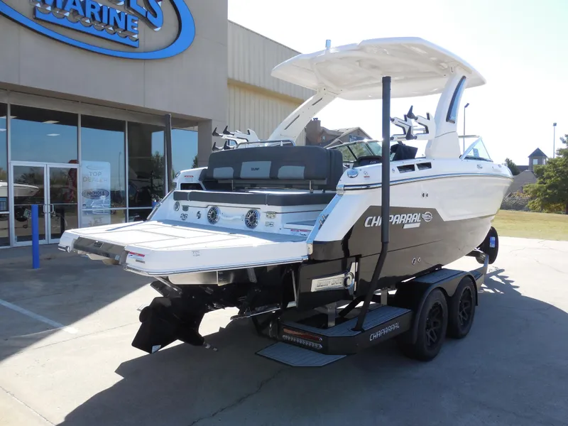 Slide: The Image of 2025 Chaparral 26 Surf boat on trailer outside dealership. - 3