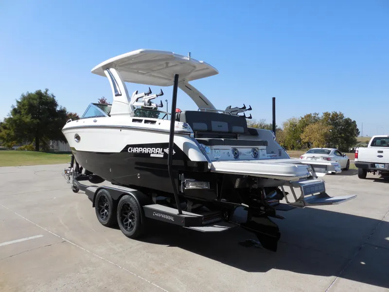 Slide: The Image of 2025 Chaparral 26 Surf boat on trailer in sunny outdoor setting. - 5