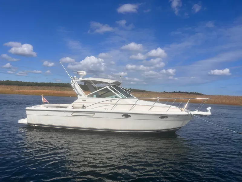 Slide: The Image of 1995 Tiara Yachts 2900 Open cruising on a sunny day with blue skies. - 0