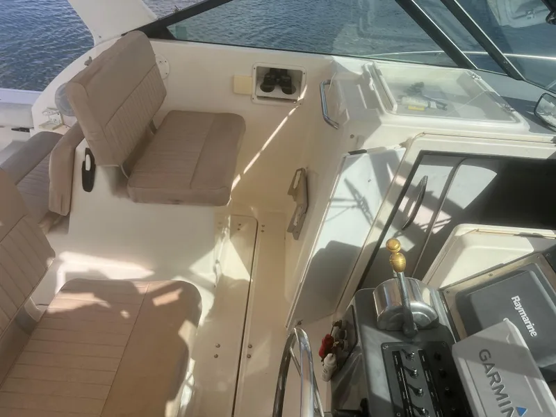 Slide: The Image of 1995 Tiara Yachts 2900 Open cockpit with beige seating and navigation equipment. - 13