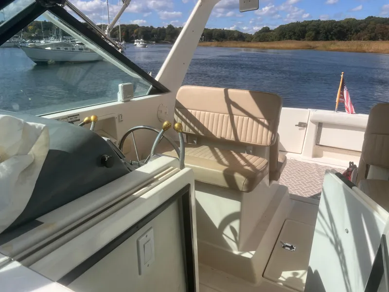 Slide: The Image of 1995 Tiara Yachts 2900 Open interior with helm, seating, and water view. - 14