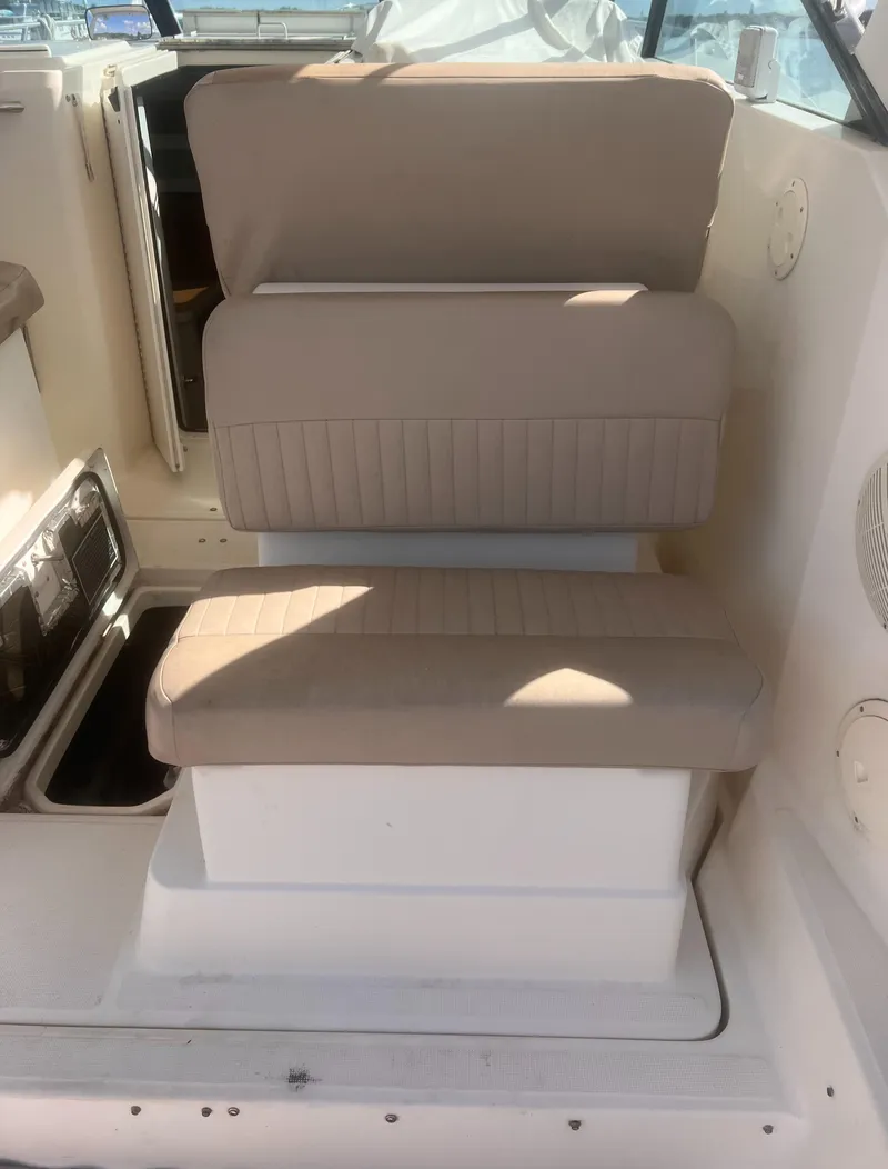 Slide: The Image of 1995 Tiara Yachts 2900 Open interior seating with beige cushions. - 17