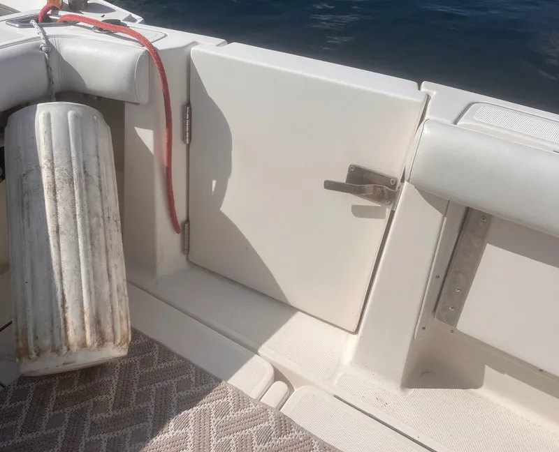 Slide: The Image of 1995 Tiara Yachts 2900 Open boat interior with storage compartment and fender. - 19