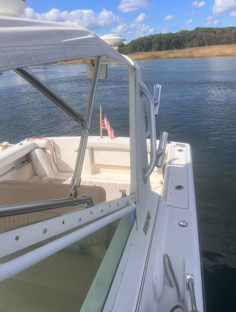 Slide: The Image of 1995 Tiara Yachts 2900 Open on calm water, showcasing deck and cabin details. - 20