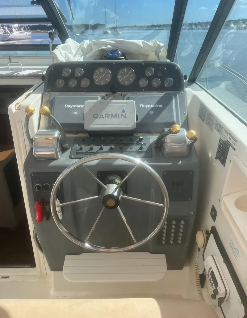 Slide: The Image of 1995 Tiara Yachts 2900 Open helm with Garmin navigation and Raymarine equipment. - 21