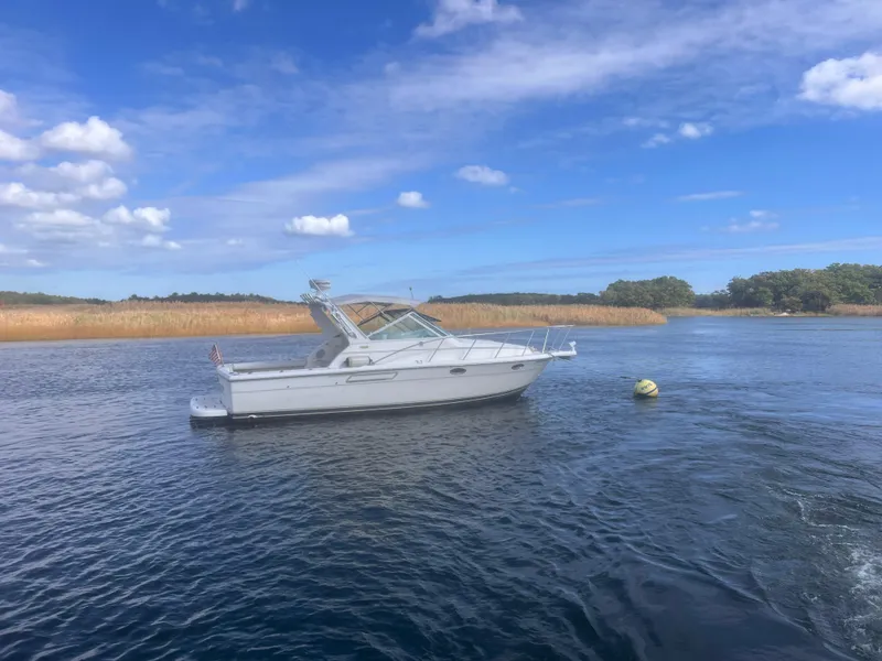 Slide: The Image of 1995 Tiara Yachts 2900 Open on calm water under a blue sky. - 3