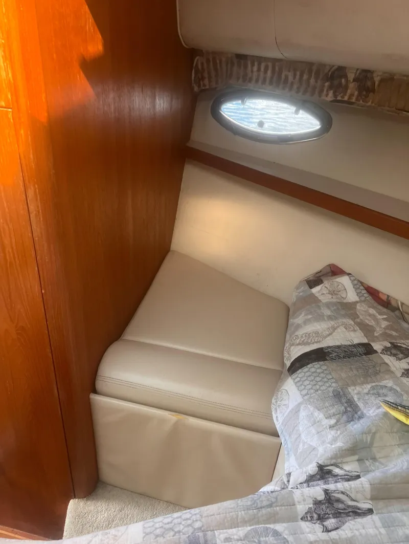 Slide: The Image of Interior cabin of a 1995 Tiara Yachts 2900 Open, featuring a cozy seating area. - 33