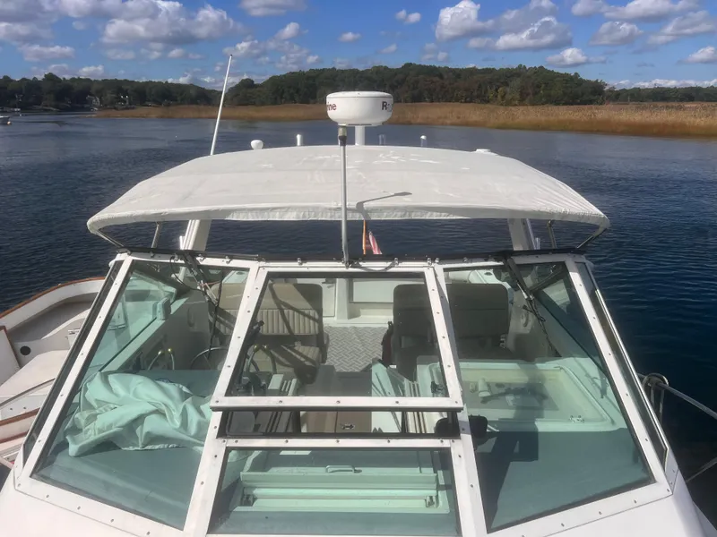 Slide: The Image of 1995 Tiara Yachts 2900 Open on calm water under a blue sky. - 4