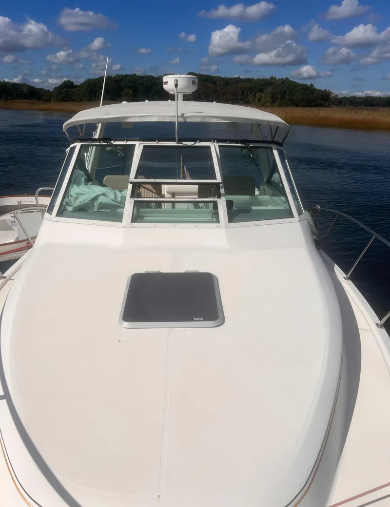 Slide: The Image of 1995 Tiara Yachts 2900 Open on water, clear sky, front view. - 6