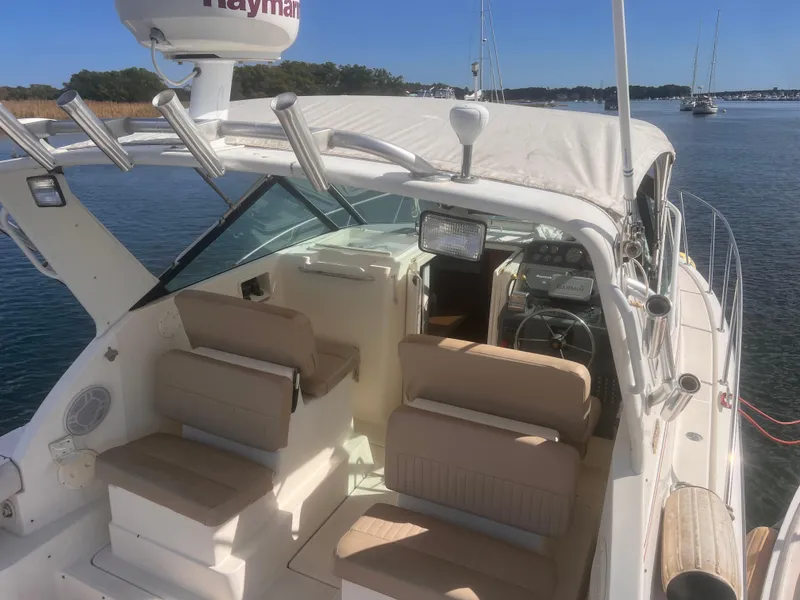 Slide: The Image of 1995 Tiara Yachts 2900 Open boat with beige seating, docked on calm water. - 9