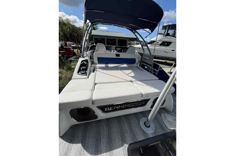 Slide: The Image of 2025 Bennington 25QXSBWA pontoon boat with spacious seating and sleek design. - 11
