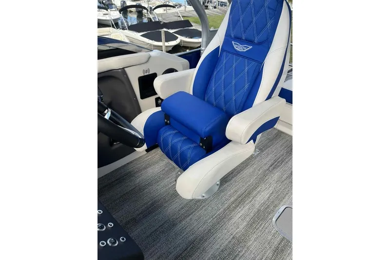 Slide: The Image of Luxurious blue and white captain's chair on 2025 Bennington 25QXSBWA boat. - 13