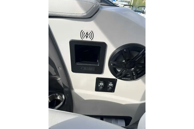 Slide: The Image of Interior of 2025 Bennington 25QXSBWA boat featuring speaker and control panel. - 14