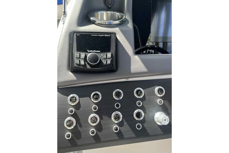 Slide: The Image of Control panel of 2025 Bennington 25QXSBWA boat featuring Rockford Fosgate audio system. - 17