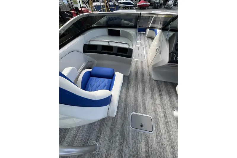 Slide: The Image of Interior of 2025 Bennington 25QXSBWA boat with modern seating and sleek design. - 18