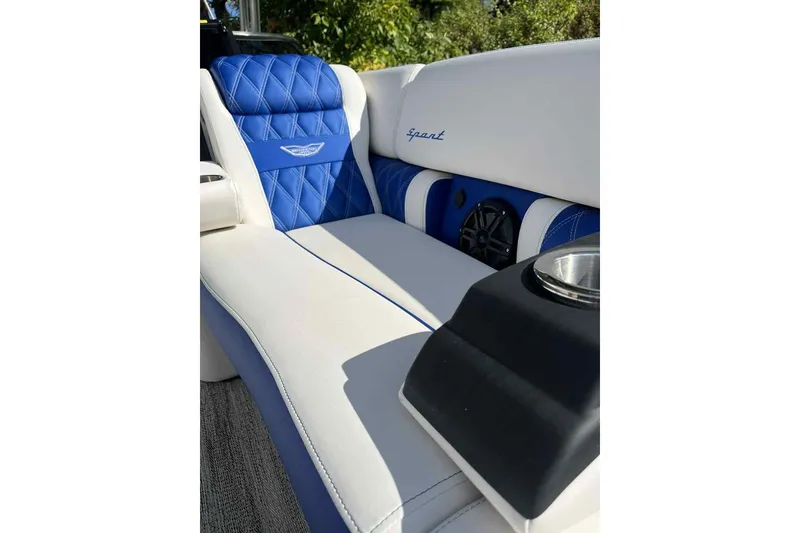Slide: The Image of Luxurious seating on 2025 Bennington 25QXSBWA boat with blue and white upholstery. - 23