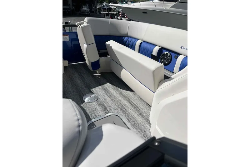 Slide: The Image of Luxurious interior of 2025 Bennington 25QXSBWA boat with blue and white seating. - 27