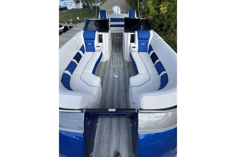 Slide: The Image of Luxurious 2025 Bennington 25QXSBWA boat interior with blue and white seating and modern design. - 7