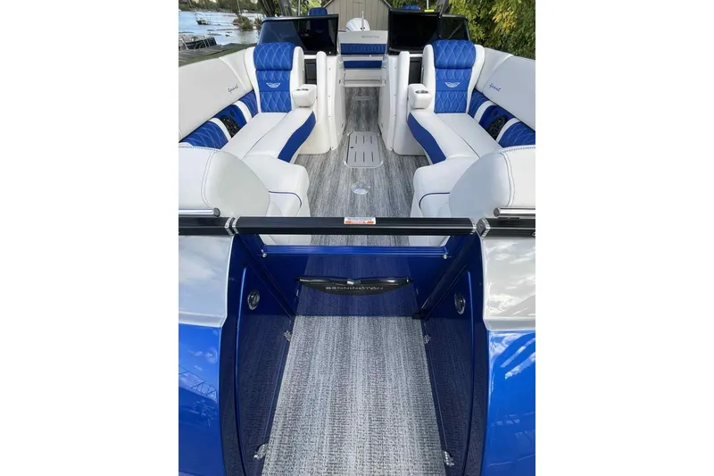 Slide: The Image of Interior of 2025 Bennington 25QXSBWA boat with blue and white seating, sleek design. - 8
