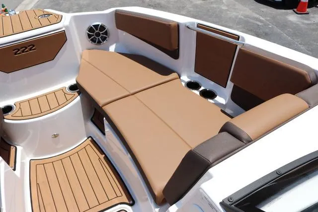 Slide: The Image of 2025 Yamaha Boats 222S interior with brown seating and cup holders. - 14