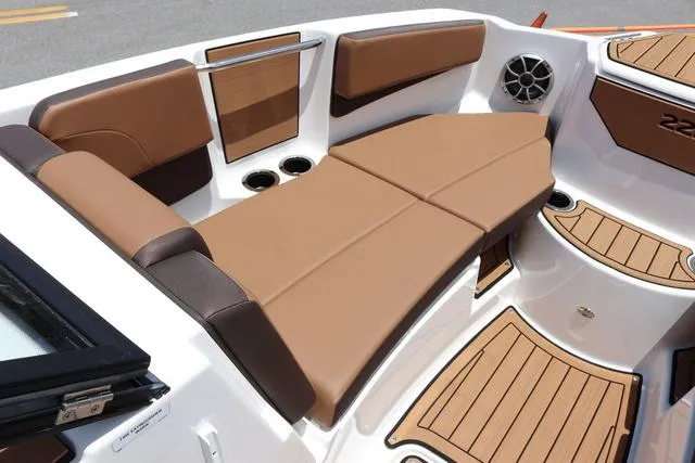 Slide: The Image of 2025 Yamaha Boats 222S interior with brown seating and cup holders. - 15