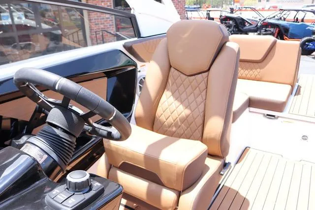 Slide: The Image of 2025 Yamaha Boats 222S interior with tan leather seats and modern steering wheel. - 18