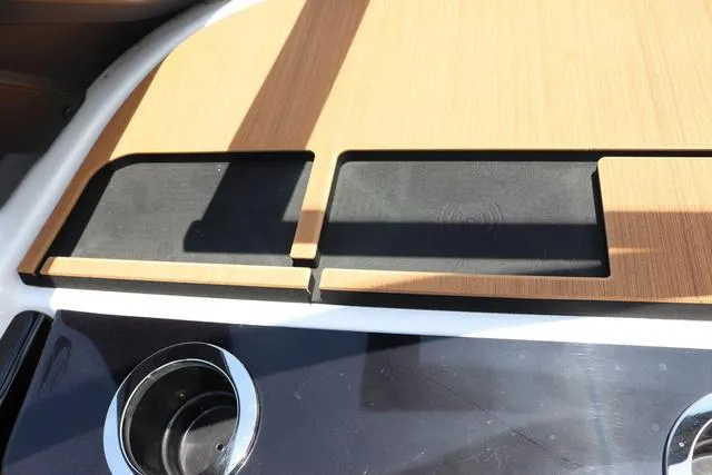 Slide: The Image of 2025 Yamaha Boats 222S interior detail with cup holders and sleek design. - 22