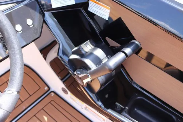 Slide: The Image of 2025 Yamaha Boats 222S control panel with sleek black and wood finish. - 26