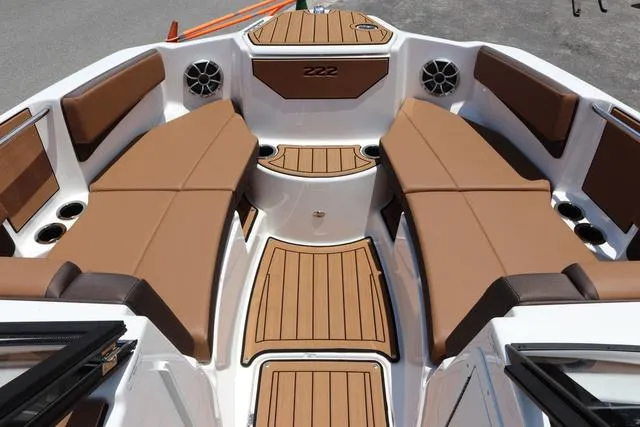 Slide: The Image of 2025 Yamaha Boats 222S interior with brown seating and sleek design. - 28