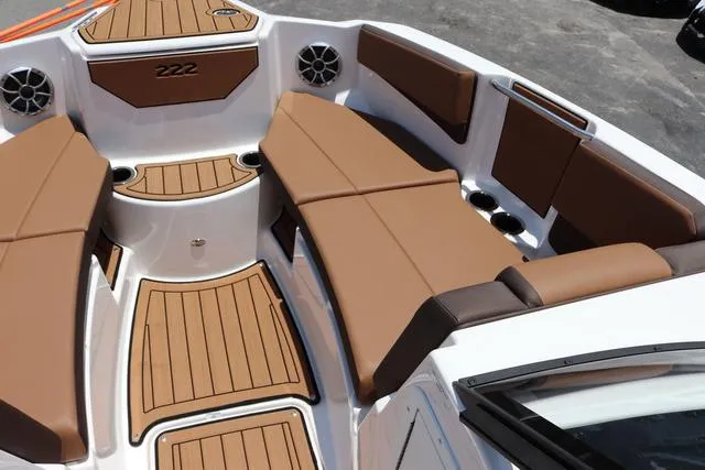 Slide: The Image of 2025 Yamaha Boats 222S interior with brown seating and teak-style flooring. - 29