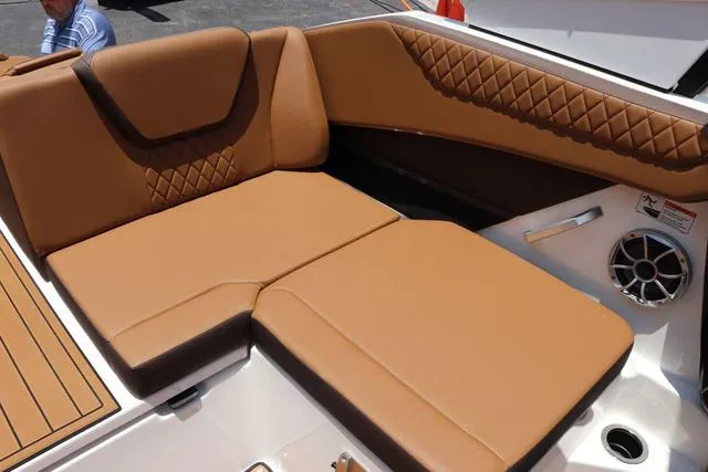 Slide: The Image of 2025 Yamaha Boats 222S interior with tan leather seating and speaker detail. - 35
