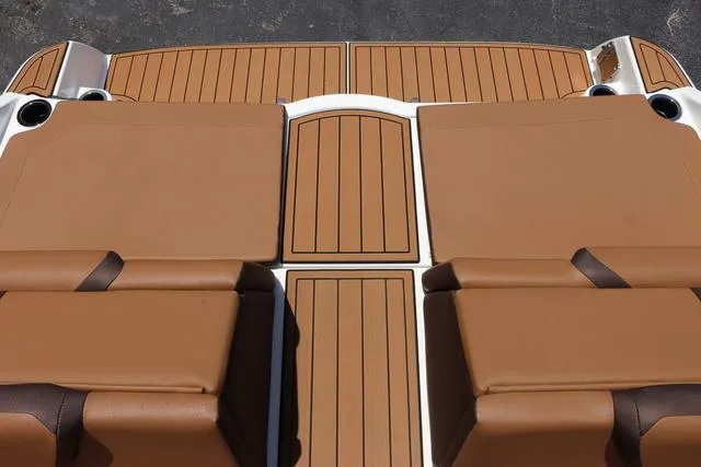 Slide: The Image of 2025 Yamaha Boats 222S-BLACK-GALVANIZED deck with brown cushioned seating and wood-style flooring. - 36