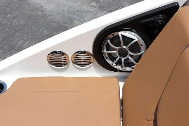 Slide: The Image of 2025 Yamaha Boats 222S interior with tan seating and sleek speaker design. - 37