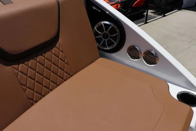 Slide: The Image of 2025 Yamaha Boats 222S interior with brown leather seating and speaker system. - 38