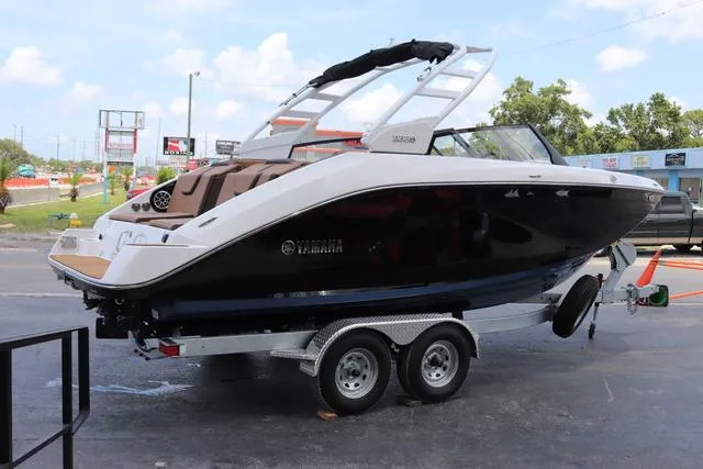 Slide: The Image of 2025 Yamaha Boats 222S interior, sleek white seating, modern design, spacious layout. - 5