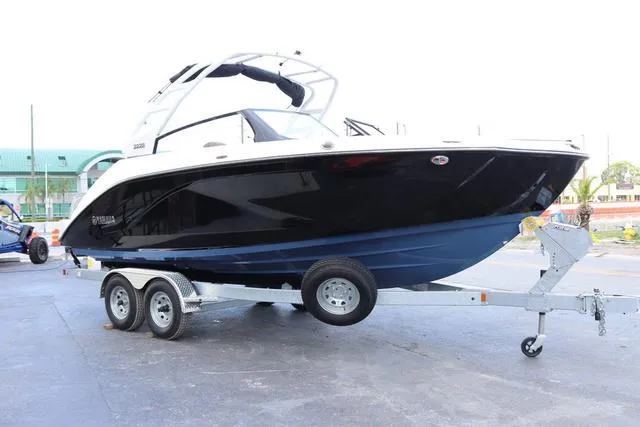 Slide: The Image of 2025 Yamaha Boats 222S interior with storage compartment and steering wheel. - 7