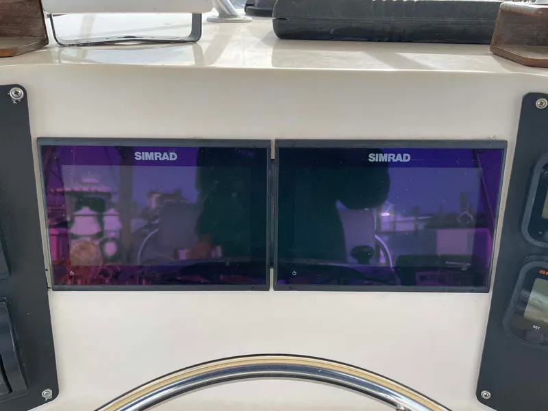 Slide: The Image of 1989 Rybo Runner Center Console with dual Simrad displays on the dashboard. - 10